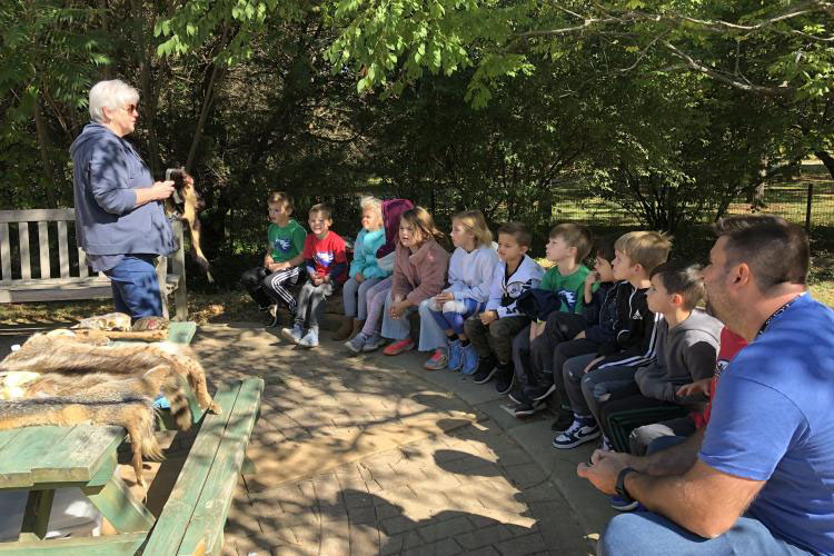 A volunteer teaches a group of children at the KCG